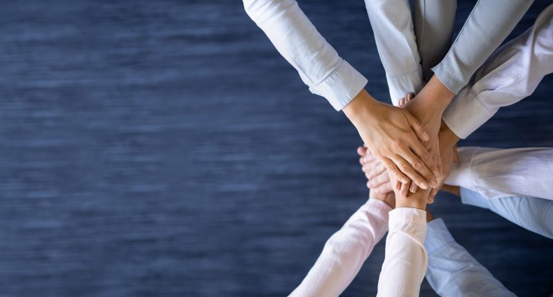 Top view of hands joining together