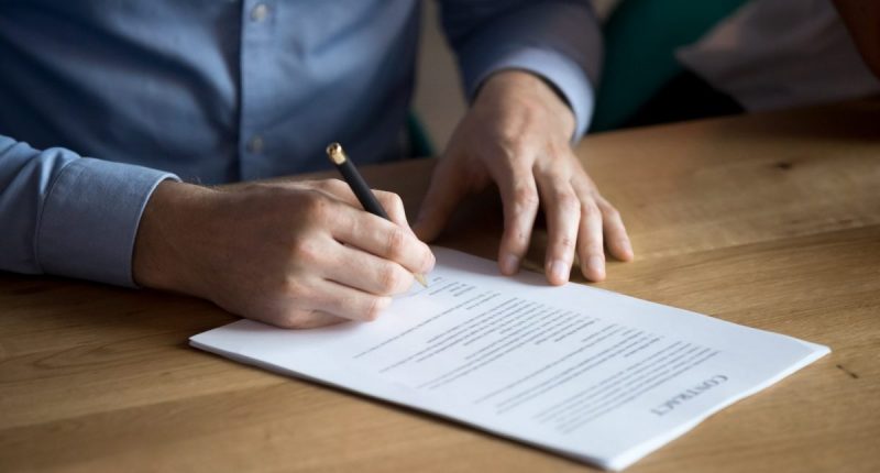 Man signing a document