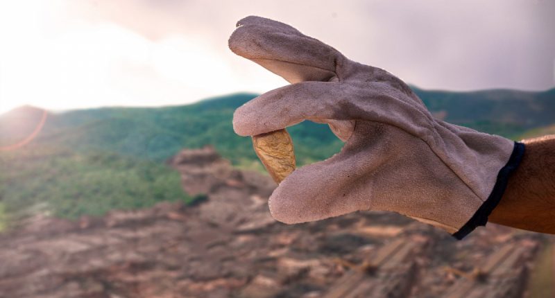 Agnico Eagle Mines Ltd. promotional image of a gloved hand holding a gold nugget