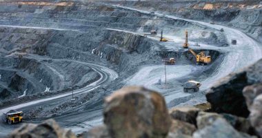 Work of heavy equipment in an open pit for gold ore mining