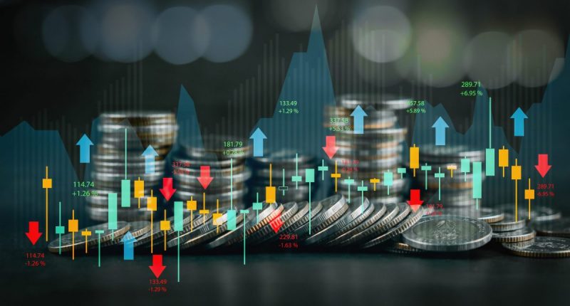 Coins overlaid with stock market graphs for Artificial Intelligence investing