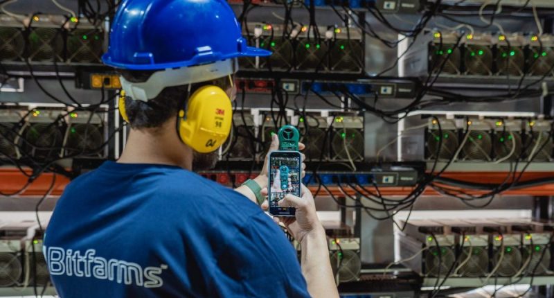 A Bitfarms employee works on a server