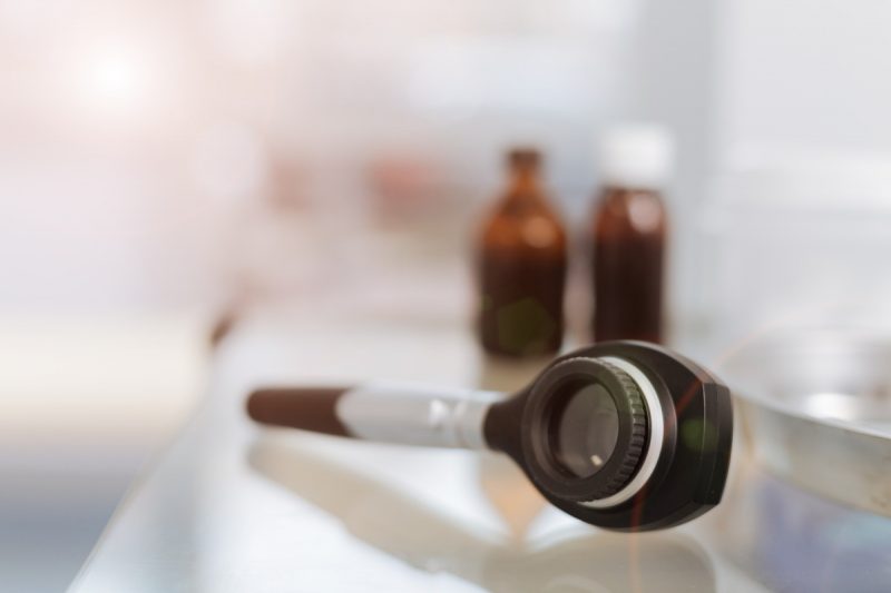 Image description: Dermatoscope lying on the table in the cabinet of the doctor