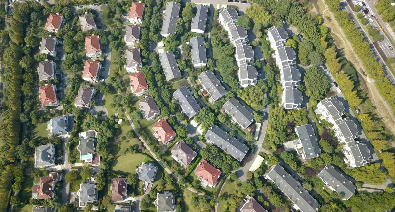 A housing community surrounded by trees.