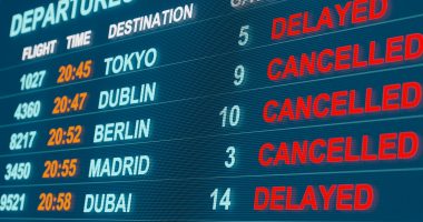Flight cancellations and delays on a digital screen.
