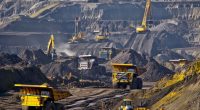 Trucks and excavators at work in an open pit gold mine.