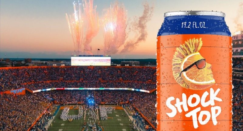 Shock Top beer can in front of a football stadium.