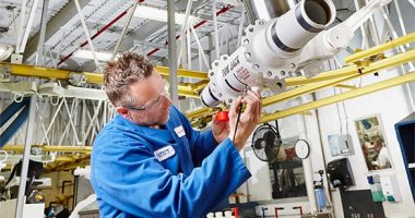 Factory employee working on equipment.