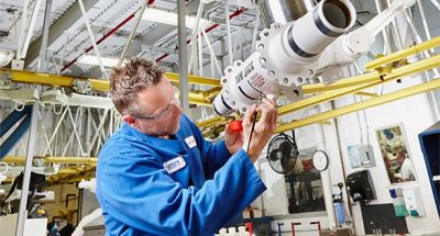 Factory employee working on equipment.