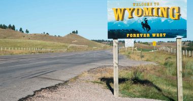 Highway sign indicating the border of Wyoming, looking east from South Dakota