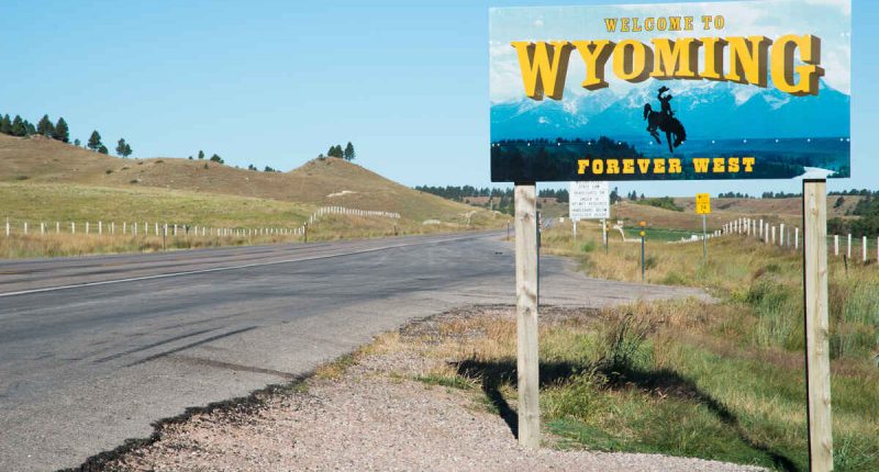 Highway sign indicating the border of Wyoming, looking east from South Dakota