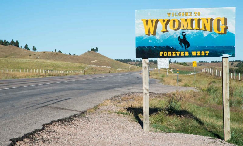 Highway sign indicating the border of Wyoming, looking east from South Dakota