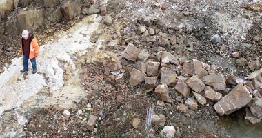 Northstar Gold worker surveying a dig site.