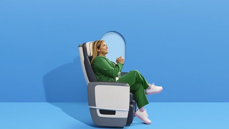 Woman in an airplane passenger seat.