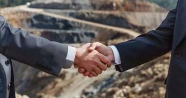 Shaking hands at a mine site