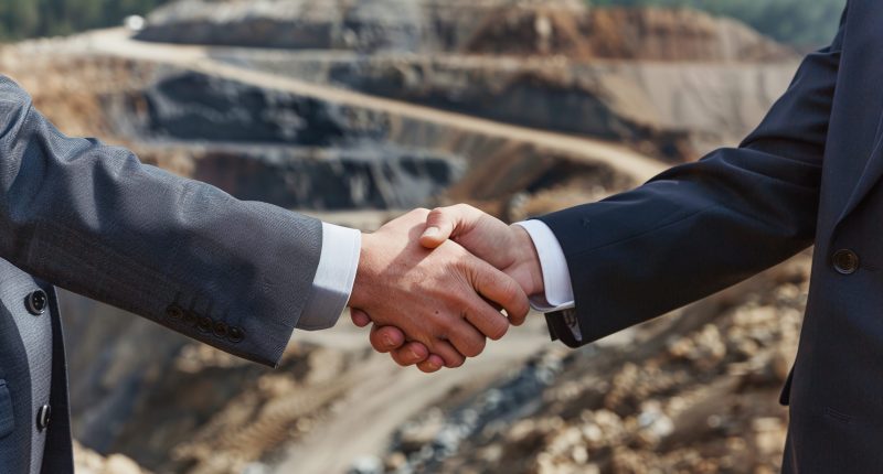 Shaking hands at a mine site