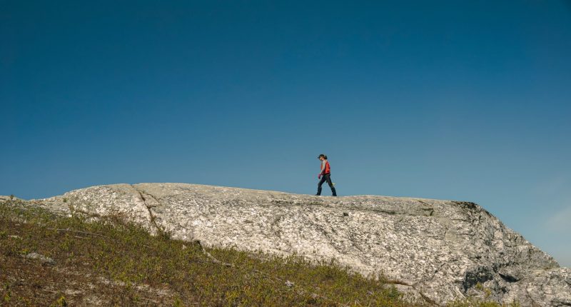 Q2 Metals vice president of exploration Neil McCallum walking on the exposed CO1 outcrop at the Cisco lithium property in Quebec