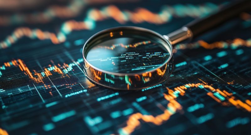 Magnifying glass and stock charts