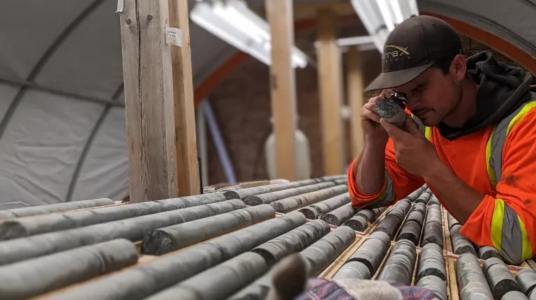 Gold Terra senior project geologist Ryan Bachynski examining drill core