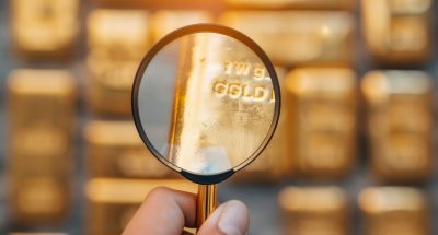 Gold bars under magnifying glass