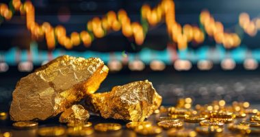 Gold nuggets and coins with a stock chart