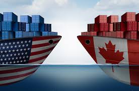 tip of two ships, one US, one Canada, with shipping containers on them